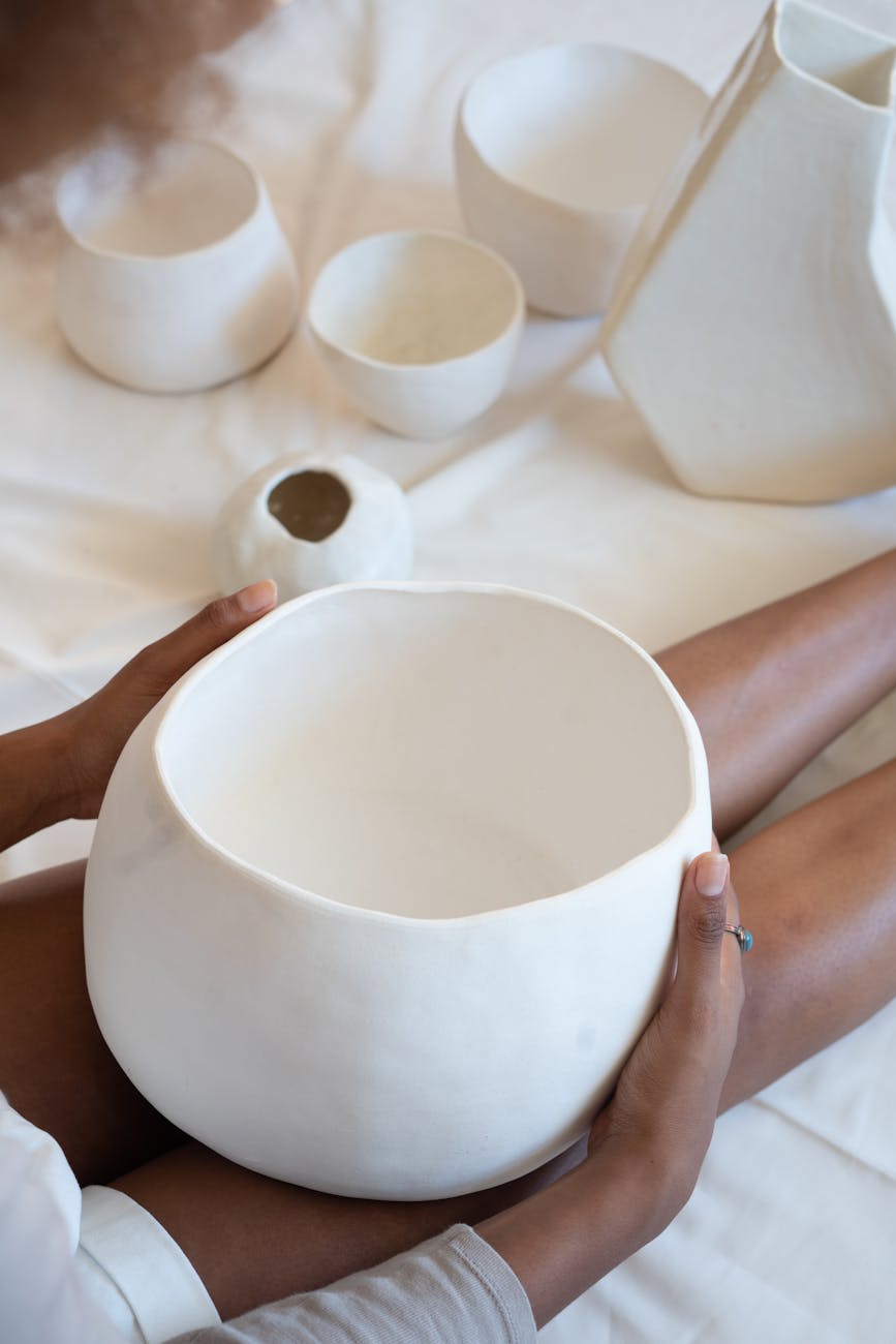 black craftswoman with handmade ceramic bowl in workshop