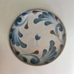 Ocean spray ozara: a wide shallow bowl with feathery cobalt blue leaf scrolls and brown teardrops over a cream speckled glaze