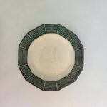 Bamboo Edge octagonal plate with a wide rim carved into bamboo-node segments in deep forest green around a cream glazed centre